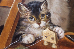 Close-up of a tabby kitten playing beside a small wooden toy
