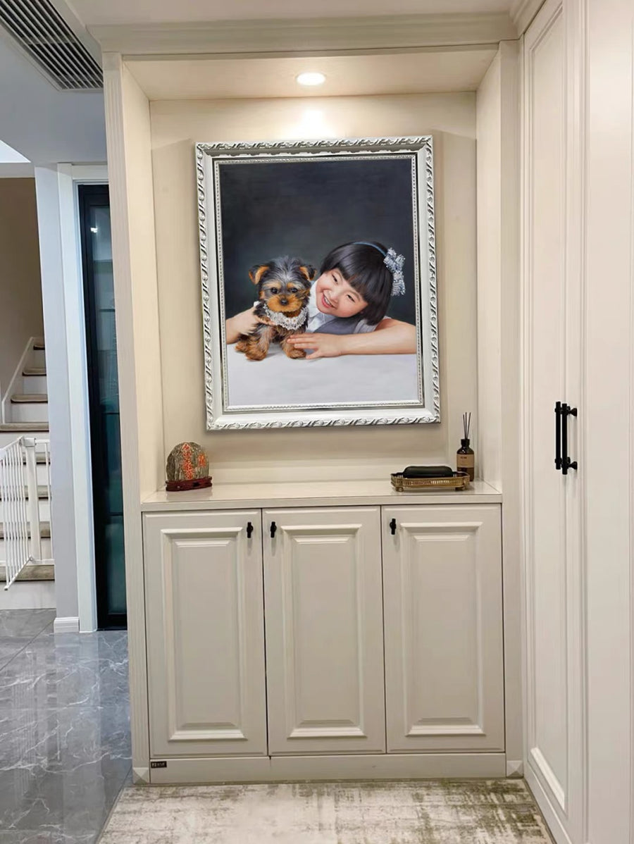 A silver-framed portrait displayed in a home, showing a smiling girl leaning beside a small brown-and-black dog against a dark background.