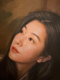Close-up of the woman’s face showing softly modeled features and canvas texture