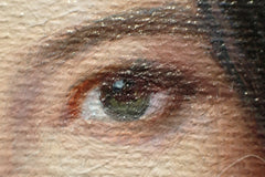 Close-up of a painted green eye with textured brushwork