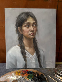 Classical portrait of a young woman displayed with an artist's palette and brushes