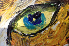 Close-up of a blue-green cat eye painted in thick impasto