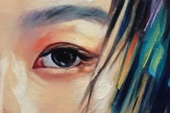Close-up of an eye, eyebrow, and colorful hair details in a contemporary portrait