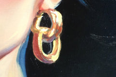 Close-up of gold earrings and the painted surface of a contemporary portrait